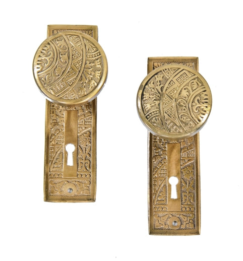 late 19th century american eastlake style ornamental wrought brass "ceylon" pattern doorknobs with matching backplates