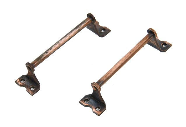 two matching petite-sized early 20th century american unornamented steel cabinet drawer pulls with original copper-plated finish