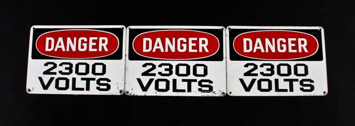 three matching original c. 1940's american industrial new old stock high voltage factory cautionary or danger single-sided signs