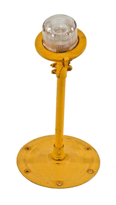 unusual american industrial brightly colored yellow enameled airfield landing strip or runway light with weather-resistant clear glass bulb guard
