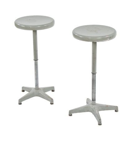 pair of original mid-century fully functional four-legged tubular steel gray enameled adjustable height stationary factory stools