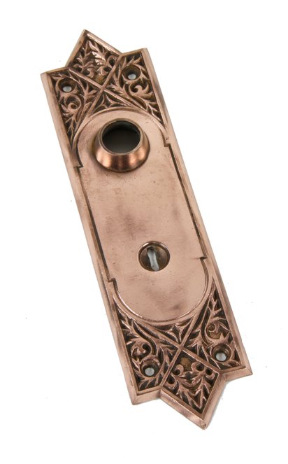 original late 19th century interior residential ornamental cast bronze "450" pattern doorknob backplate with intricate filigree design motifs
