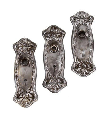 matching lot of three c. 1900-10 american art nouveau style "nouvelle" pattern stamped steel residential doorknob backplates
