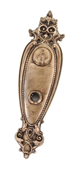 c. 1900's original antique american exterior residential ornamental cast brass doorknob backplate with uniform surface patina.