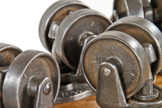 lot of four matching original and functional reinforced american industrial refinished iron and steel "roll ezy chief" swivel casters