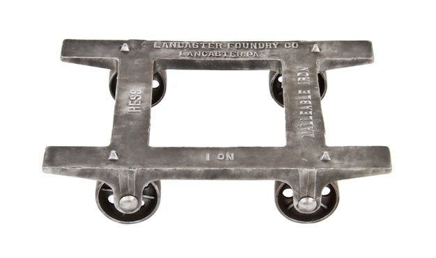 early 20th century american industrial low-lying refinished iron foundry cart with original and intact pierced caster wheels