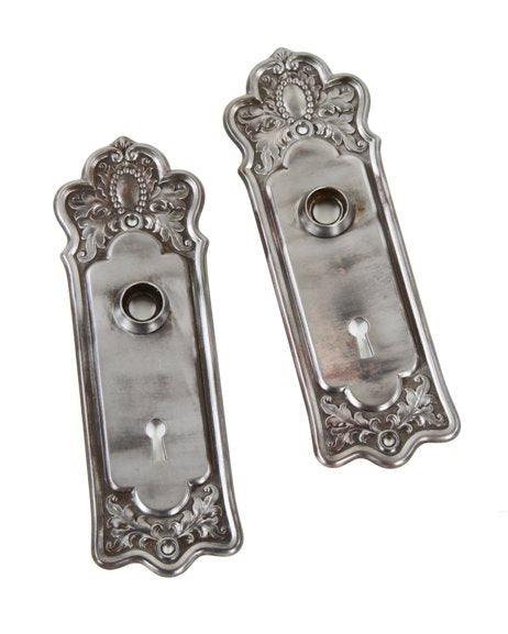 set of two deeply embossed antique american brushed steel interior residential doorknob backplates with beaded border cartouches
