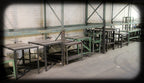 well-proportioned late 1940's american industrial angled iron factory machine shop four-legged work station with brushed metal tabletop