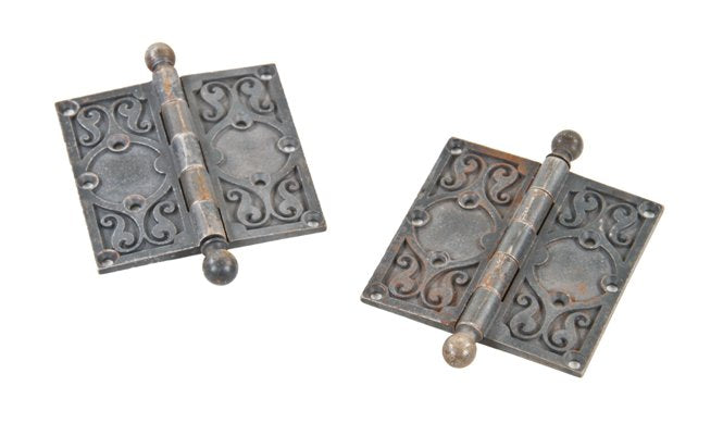 pair of original fully functional interior reliance building ornamental cast iron office door hinges with intact bower-barff plated finish