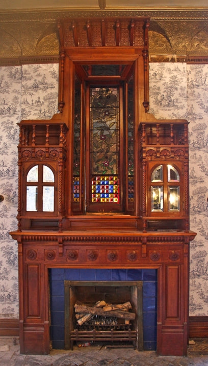 original extraordinary 19th century american hand-crafted david c. cook mansion cherry wood fireplace mantel featuring segmented beveled mirror hinged door cabinets