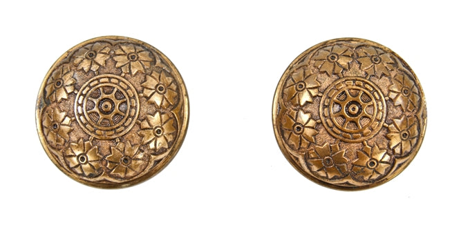 two original c. 1880's matching ornamental cast brass banded rim interior residential doorknobs with nicely aged surface patina