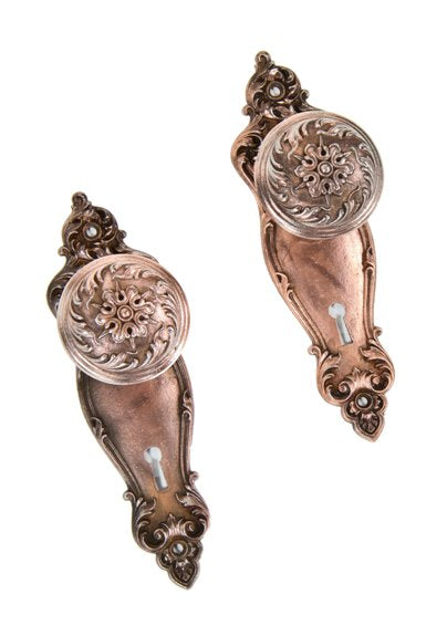 all original c. 1900's american interior residential ornamental cast iron "piccadilly" pattern passage door hardware with copper-plated finish