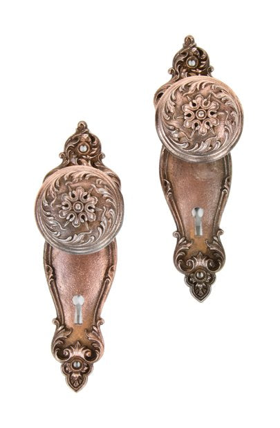 complete set of original early 20th century "piccadilly" pattern ornamental cast iron copper-plated doorknobs with matching backplates