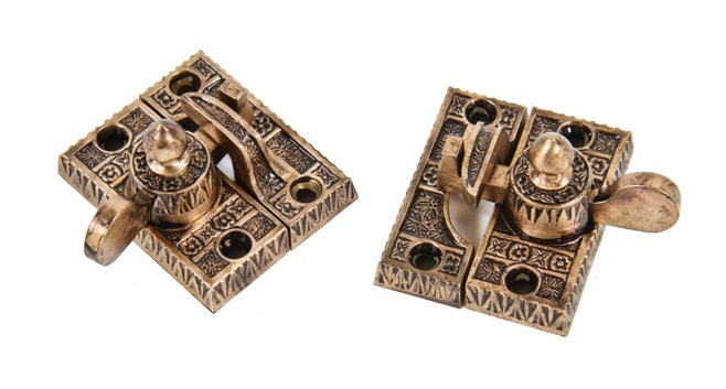 two matching oversized 19th century american ornamental cast brass "ivy" pattern interior residential window sash locks with intact keepers