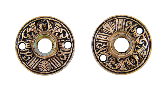 pair of matching c. 1880's original ornamental cast brass "egyptian" pattern interior residential passage door rosettes with protruding thimbles