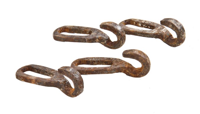group of depression era american vintage industrial interchangeable wrought iron eye grab hooks possibly used on a farmstead conveyor system