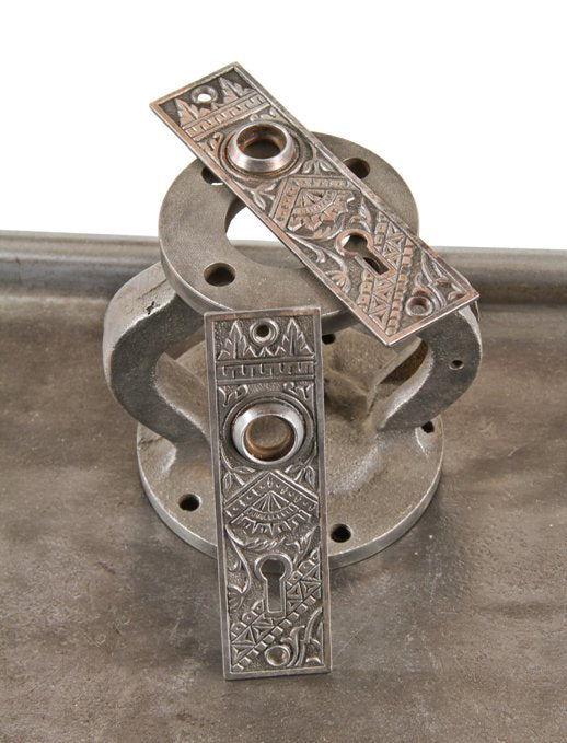matching set of original late 19th century american eastlake style ornamental cast iron residential passage door backplates with steel thimbles