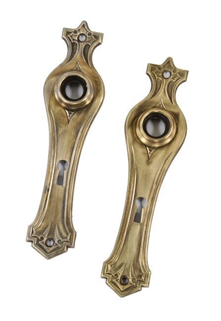 pair of distinctive late 1920's american interior residential stamped steel and brass passage door backplate or escutcheons