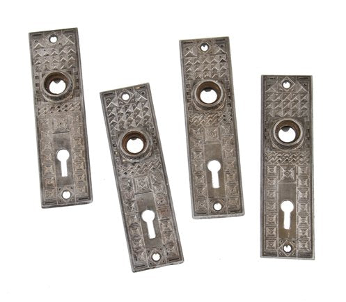 four matching original strongly geometric 19th century american ornamental refinished cast iron residential passage door backplates