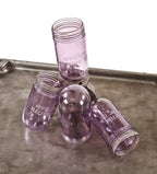 pair of matching rare c. 1914 american industrial "sun purple" explosion proof threaded end bulb guards with lightly etched lettering