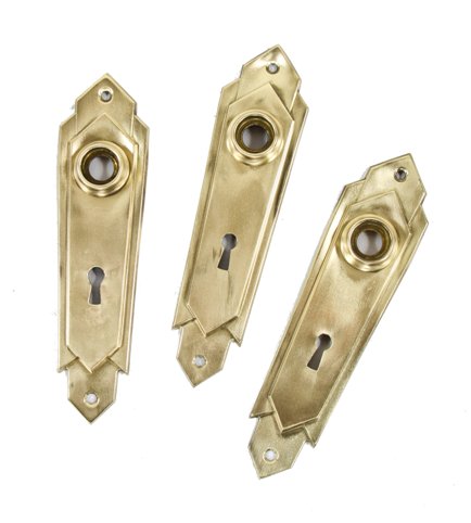 set of three matching c. 1920's american machine age stamped yellow brass "skyscraper style" interior residential doorknob backplates with brushed metal finish