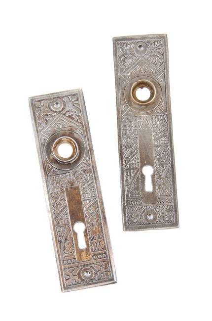 set of late 19th century antique american ornamental stamped steel "ceylon" pattern interior residential doorknob backplates with intact thimbles