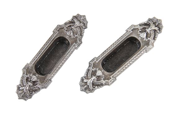 two matching early 20th century american ornamental cast iron "ontario" pattern interior residential window sash pulls with deeply recessed cups