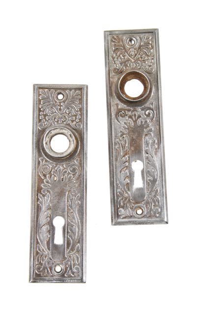 matching set of c. 1900's american antique interior residential stamped or pressed wrought ornamental steel doorknob backplates or escutcheons
