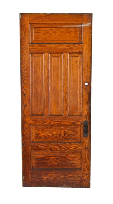 skillfully crafted early 20th century oversized american antique interior residential vestibule oak wood raised panel door with "loriane" pattern escutcheon