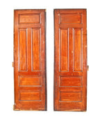 original and intact oversized early 20th century american made varnished oak wood raised panel interior residential sliding pocket doors