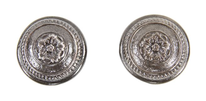 pair of original early 20th century american ornamental cast iron passage size "yucca" pattern residential doorknobs with centrally located floral rosettes