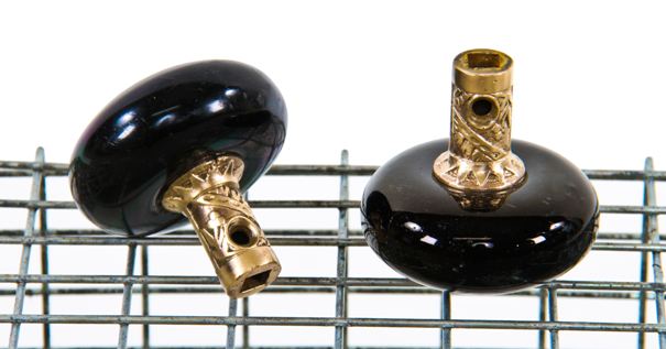 two matching late 19th century american eastlake style "jet black" porcelain residential passage size doorknob with ornamental cast brass shanks