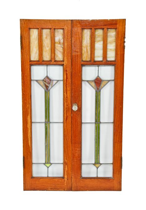 largely intact c. 1920's american interior residential arts & crafts style varnished oak wood leaded glass cabinet doors with abstract floral motifs