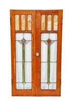 largely intact c. 1920's american interior residential arts & crafts style varnished oak wood leaded glass cabinet doors with abstract floral motifs