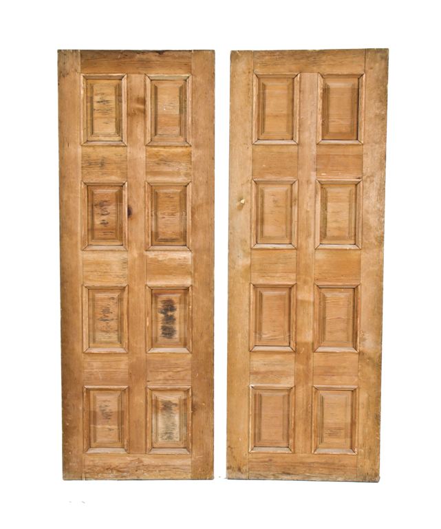 matching set of late 19th century refinished old growth pine wood commercial building doors with beveled edge raised panels surrounded by built-up trimwork