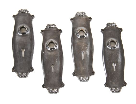 lot of four marching early 20th century antique american ornamental cast iron residential doorknob backplates with scrollwork or volute design motifs