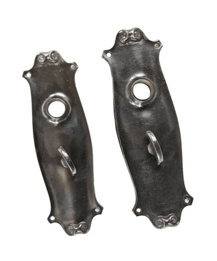 two matching early 20th century american antique ornamental cast iron interior residential doorknob backplates with privacy latches