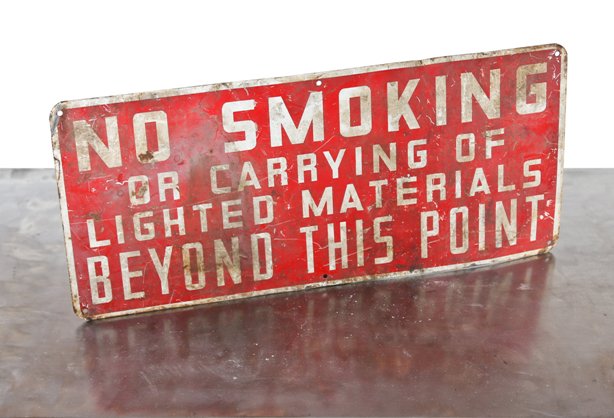 weathered and worn vintage american industrial heavy gauge steel "no smoking" red and white enameled factory cautionary sign with rounded edges