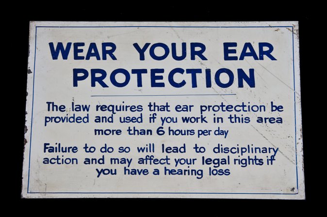 unique late 1940's vintage american industrial hand-painted white and blue enameled die cut steel "wear your ear protection" cautionary factory sign