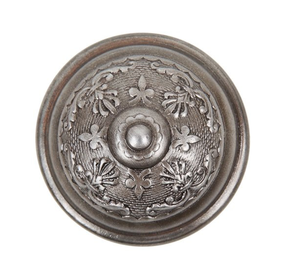 c. 1900's american ornamental interior residential wrought steel banded rim passage size doorknob featuring a centrally located embossed floral rosette