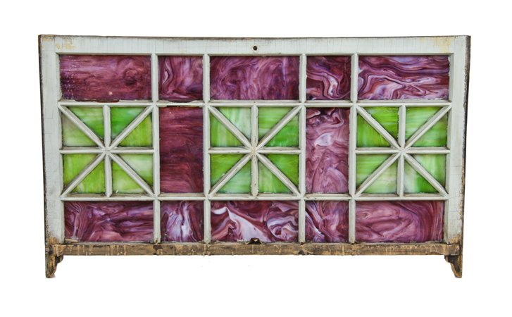 very unusual early 1920's american theater building storefront outer sash mullioned window featuring richly colored purple and green slag glass