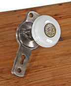unique 19th century gilbert's patent lever door hardware consisting of a stationary white porcelain knob affixed to a cast iron backplate or escutcheon