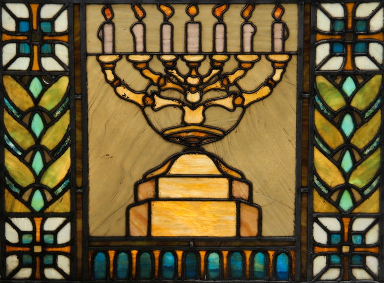 exceptionally well-made and richly colored american leaded stained glass emblematic synagogue window featuring a menorah mounted on tiered pedestal