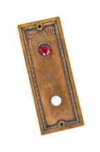 original early 20th century wall-mount ornamental cast bronze metal commercial building elevator cab call button backplate with ruby red glass indicator light