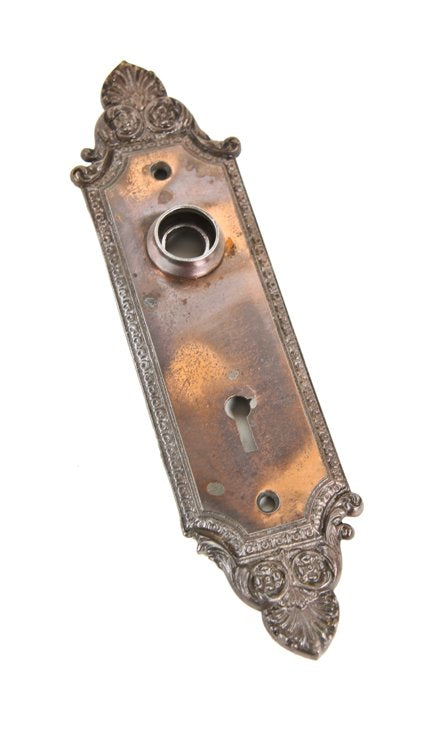 c. 1900's american interior residential ornamental cast iron "geneva" pattern residential copper-plated doorknob escutcheon or backplate