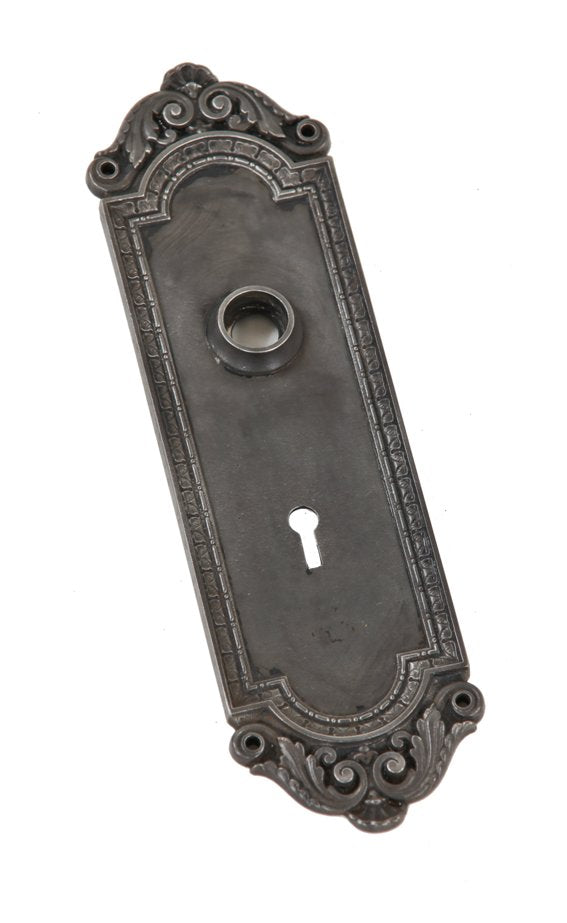 american antique "st. omer" pattern ornamental cast iron interior residential doorknob backplate with single keyhole and protruding collar