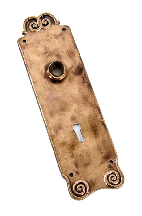single early 20th century american ornamental cast bronze metal interior residential passage door backplate or escutcheon containing scroll-like ornament