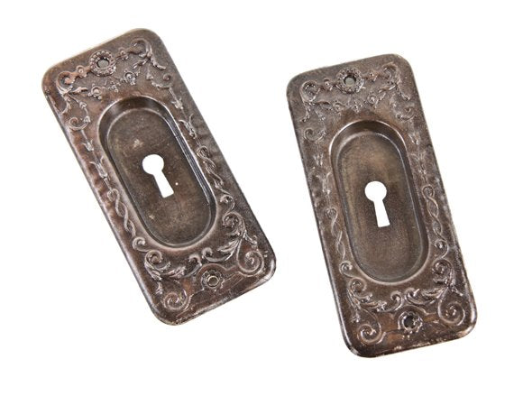 matching set of early 20th century american antique ornamental oil-rubbed bronzed wrought steel residential sliding or pocket door handles with recessed "cup" handles