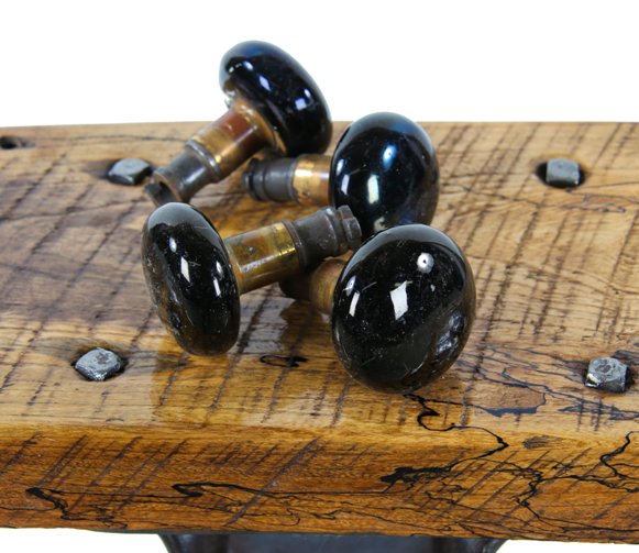 original and completely intact late 19th century jet black porcelain enameled passage door handles with "screwless" spindles