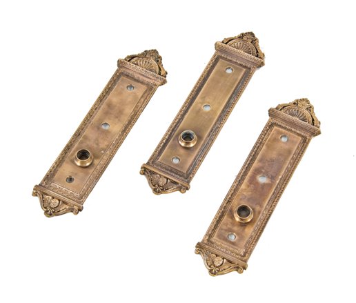 group of three matching early 20th century oversized ornamental cast bronze "portsmouth" pattern doorknob backplates replete with aquatic creatures and cherubs